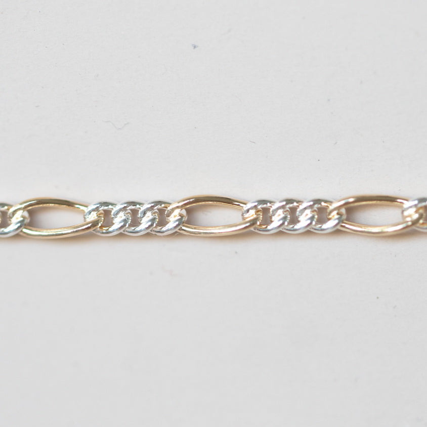 Mixed Metals Figaro Chain. Priced per inch.